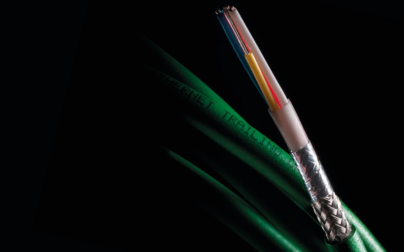 Close-up of an industrial Ethernet cable with exposed internal shielding and colour-coded conductors, highlighting durability and high-performance data transmission.