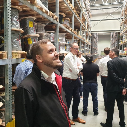 Allan Mason-Whelan photographed in awe looking at the HELU warehouse cable stock.