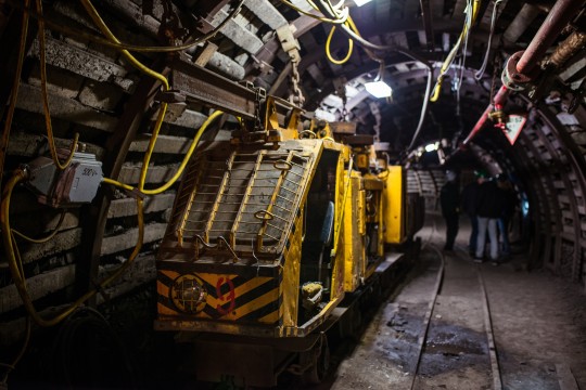 Mining equipment parked near miners