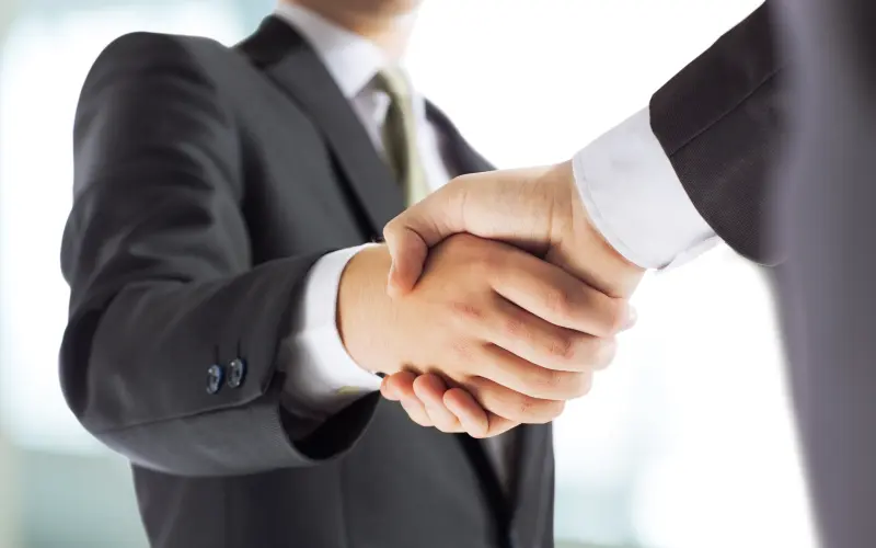 Handshake of two men in suits