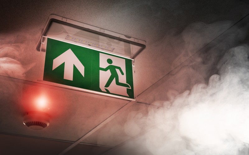 Smoke in room and green exit sign