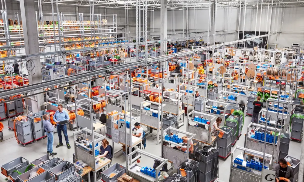 Employees assembling industrial connectors in cable assembly production.