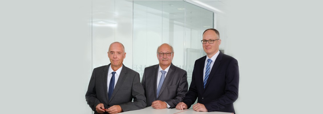 The three Managing Directors in suits of Helukabel GmbH 