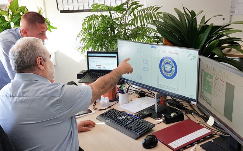 Cable designers discuss cable design at their desks