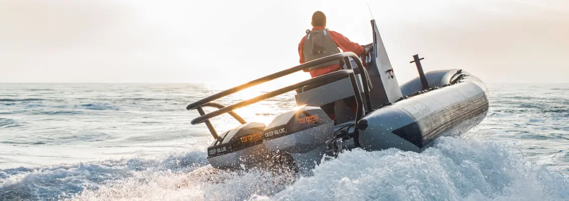 Motorboat driving in the sunset