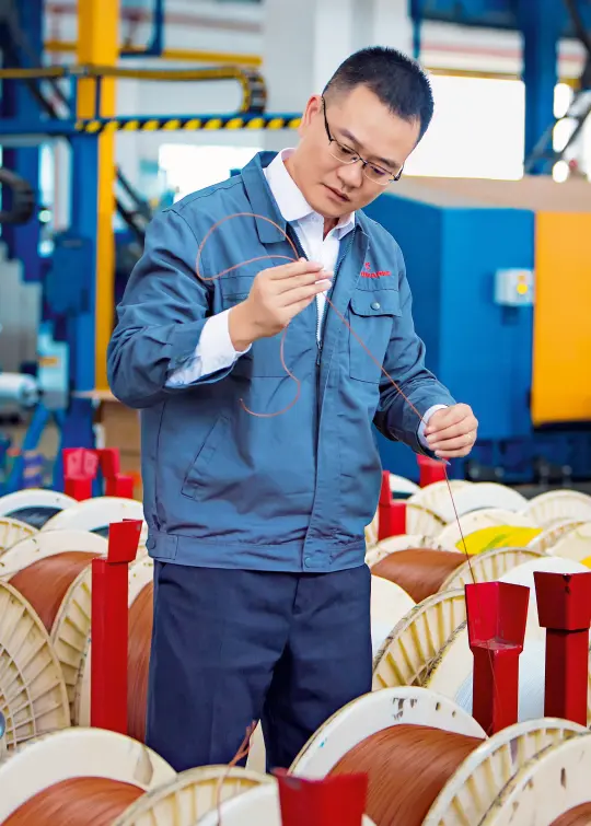 Jay Song holds a cable