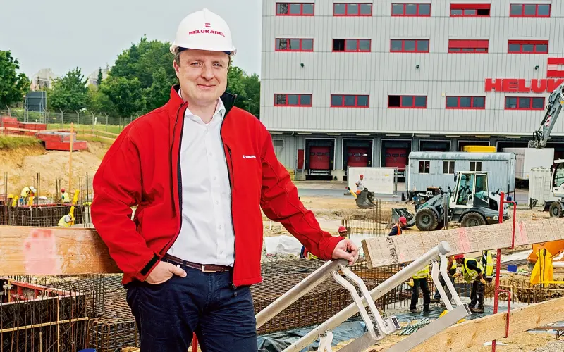 Johannes Sailer at the construction site wearing a helmet