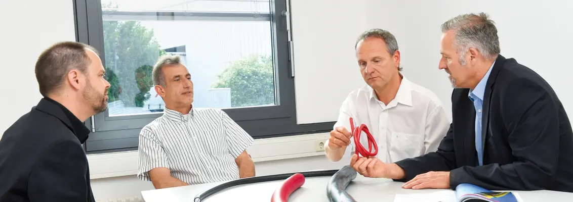 Group of gentlemen sitting at the table discussing