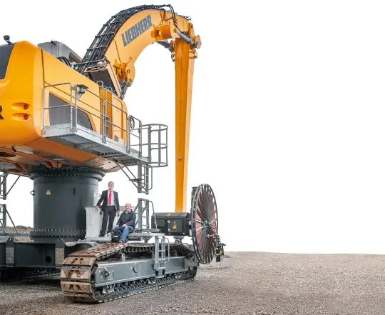 two men sitting on the excavator