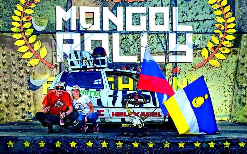 Two people sitting in front of their rallye car