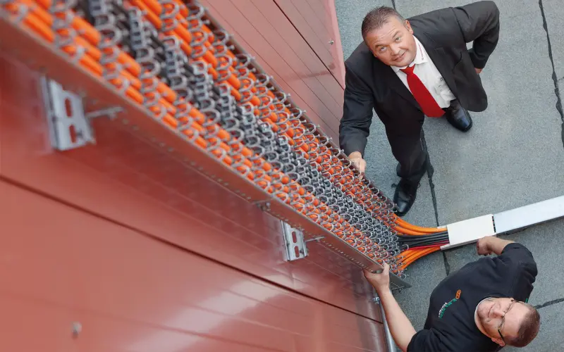 Henning Hambloch and Holger Groos inspecting the fireproof cables on the roof