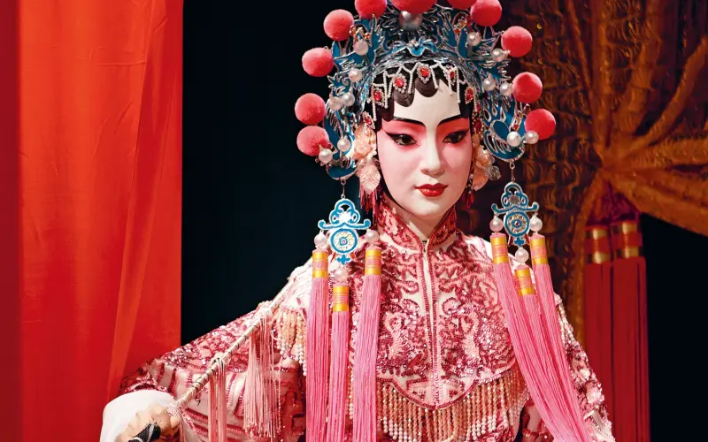 Open curtain on a stage with a woman in disguise