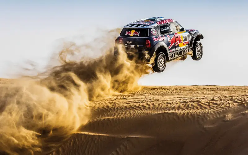 Rally car redoubt over sand dune
